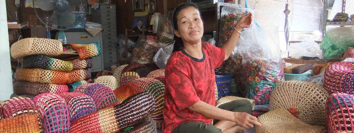 Thai home-based worker weaving handbags