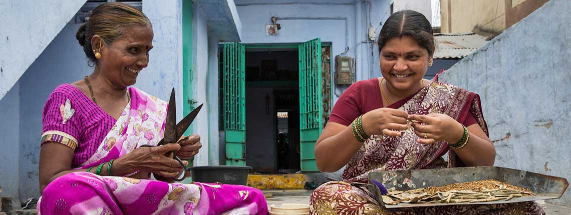 Home-based workers hand rolling Indian-style cigarettes in informal settlements in India.