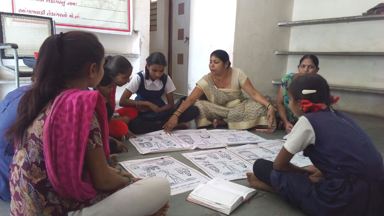 Pushpa works with young children to talk about health