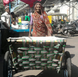 Woman pushing cart, India