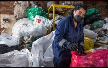 waste picker in mask and gloves