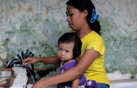 woman working with child in lap