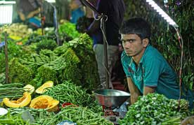 Vendors and customers at the Saturday weekly market in Vasant Kunj, Delhi.