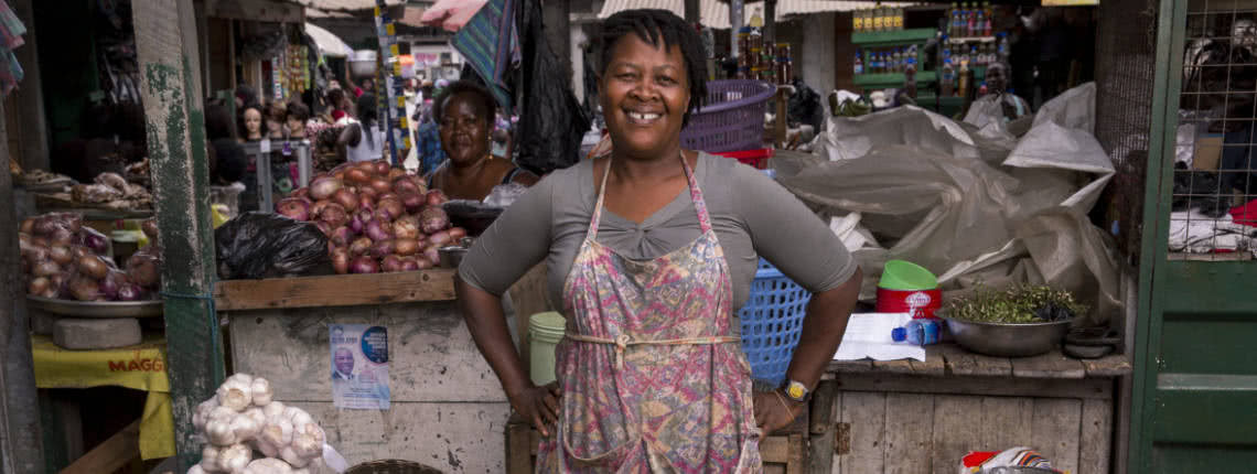 Market vendor Vida Ofori stands proudly at her tomato stand in the Makola Market.