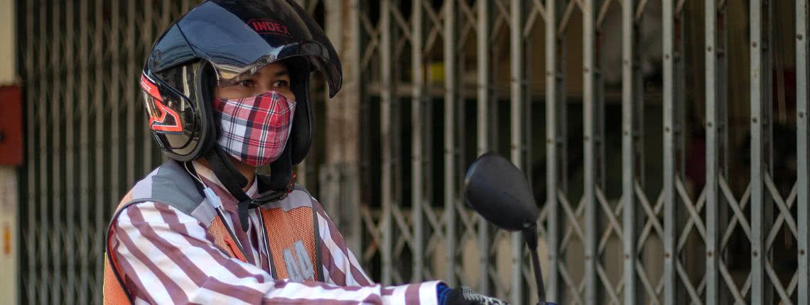 A motorcycle taxi driver waits for customers in Bangkok