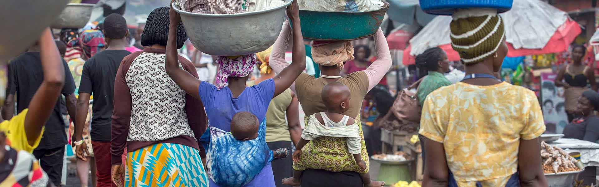 Kayayei carry goods on their heads in Kantamanto Market in Accra, Ghana