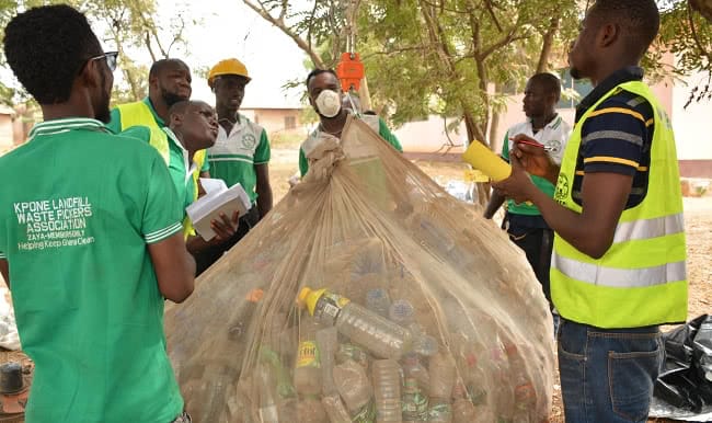 Bokk Diom waste pickers weigh material collected in Dakar