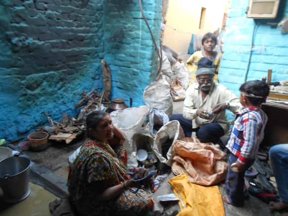 Kanataben sorting through trash with her husband