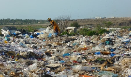 woman working at Mbeubeuss dumping site