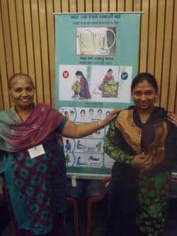 Seemaben, a SEWA embroiderer, shows off  work she created using her new embroidery frame