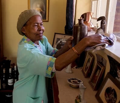 domestic worker in Johannesburg dusting