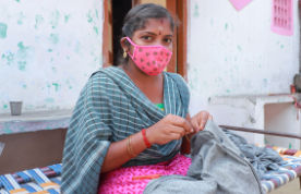 woman from Tiruppur sewing by hand at home