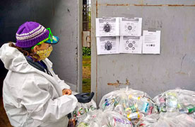 Ground Score Association worker Christine Alix reviews COVID-19 safety protocols at Ground Score’s producer-funded People’s Depot in Oregon, USA