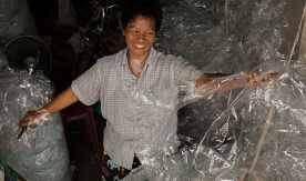 Waste picker Ananya Songsai sorts plastic at her Bangkok home. By Paula Bronstein, Getty Images