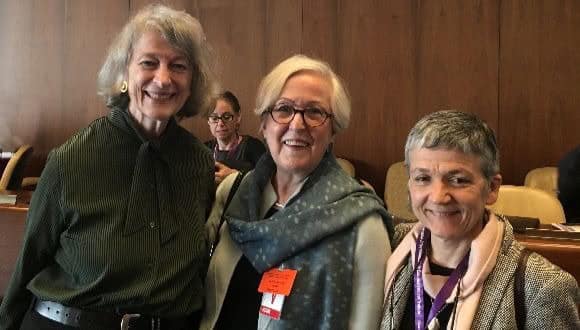 Three women from WIEGO smiling at a labour statistics conference.